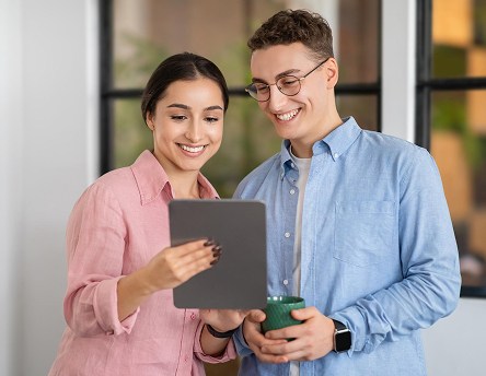 Two colleagues reviewing a website together on a tablet